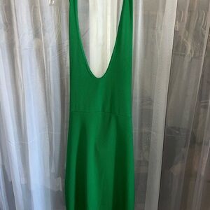 Women’s green halter neck dress, with open back and tie detail.